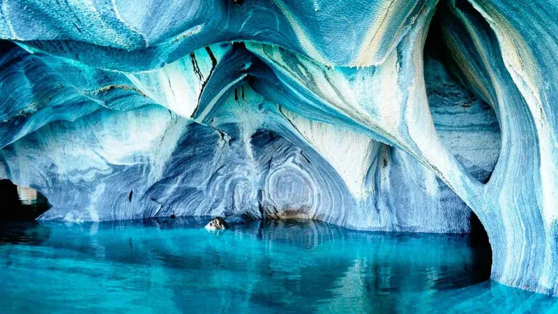 Boat passing the swirling blue Marble Cathedral on a marble caves Chile boat trip from Puerto Rio Tranquilo