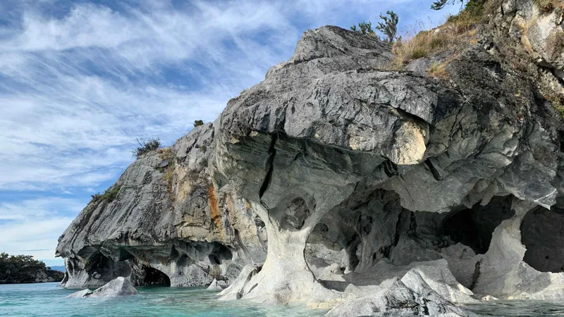 Kayaker deep inside a marble cavern on the full marble caves Chile kayak experience on Lake General Carrera