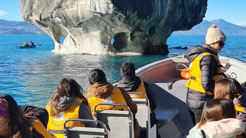First-class boat entering a wide marble cave near Puerto Sanchez on the cheapest marble caves Chile full marble tour